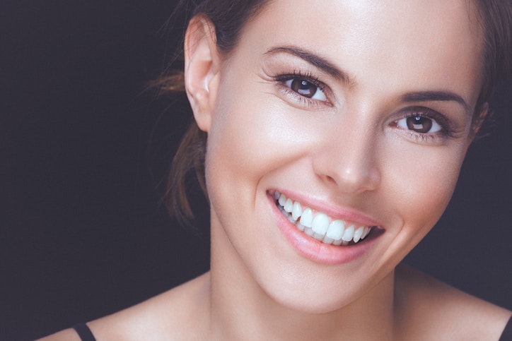 Woman without ache smiling showing teeth